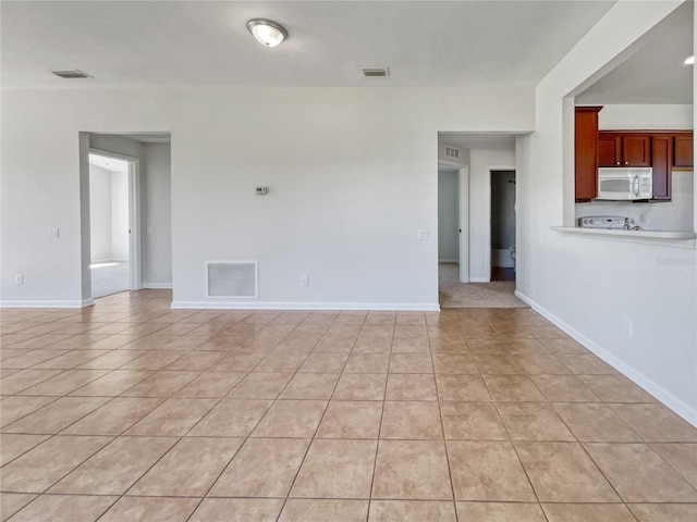 unfurnished room featuring light tile floors