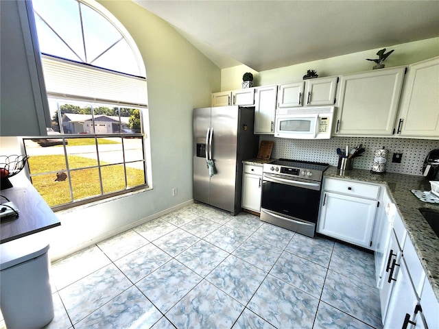 kitchen with stainless steel appliances, tasteful backsplash, white cabinetry, and light tile floors