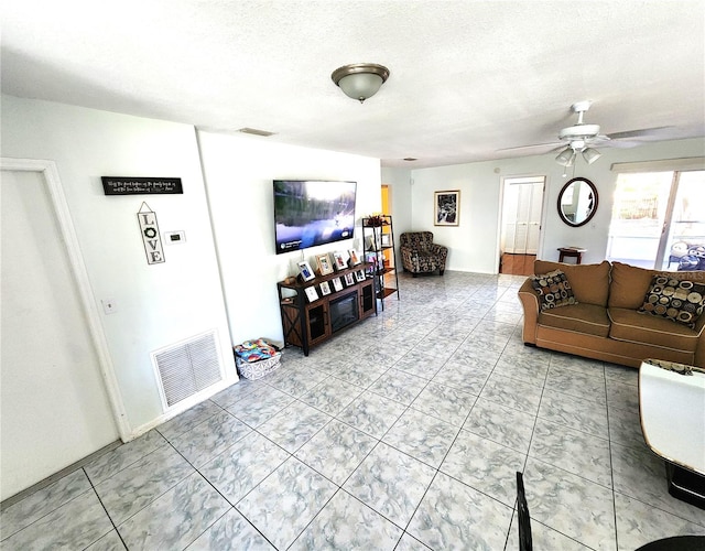 living room with ceiling fan and light tile flooring