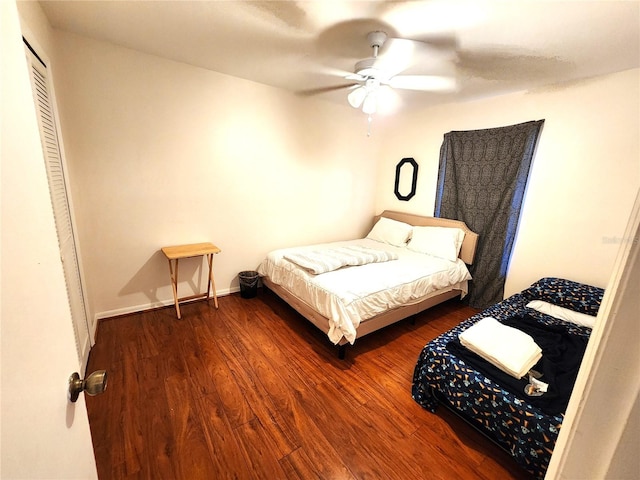 bedroom with ceiling fan, dark hardwood / wood-style floors, and a closet