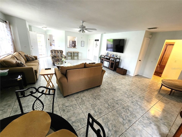 living room featuring ceiling fan and visible vents