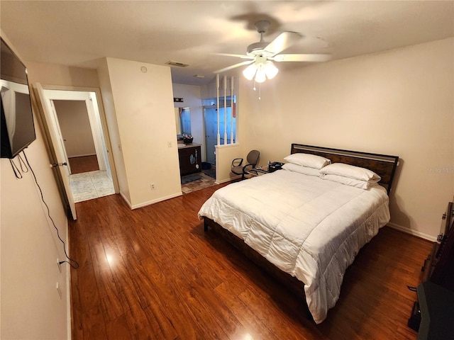 bedroom with ceiling fan, dark wood-style flooring, visible vents, and baseboards