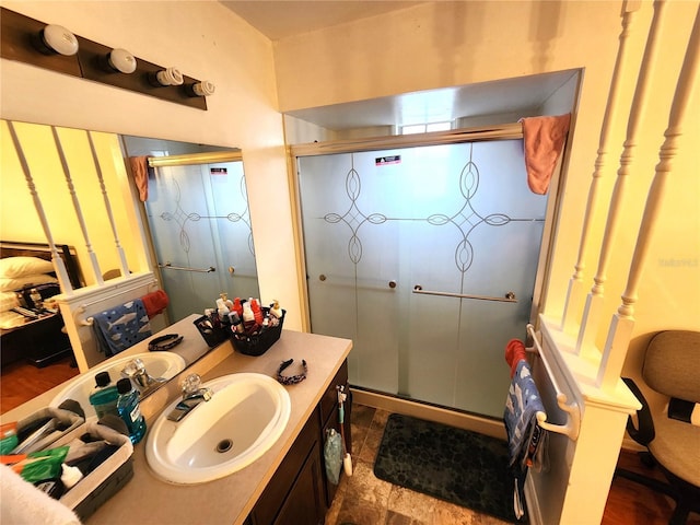 bathroom with a stall shower and vanity