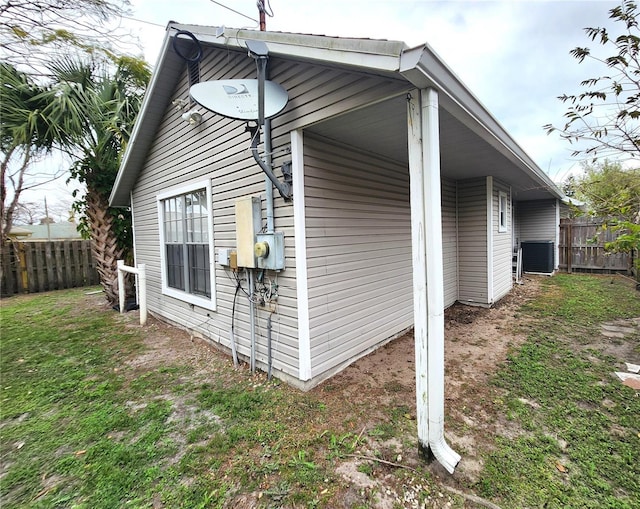 view of property exterior featuring fence and a yard