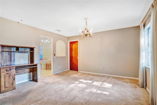 unfurnished living room with an inviting chandelier and light carpet