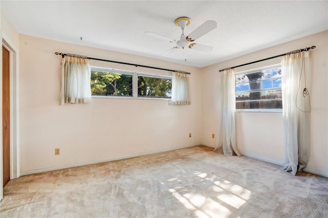 spare room with ceiling fan and carpet flooring