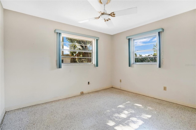 empty room featuring plenty of natural light and ceiling fan