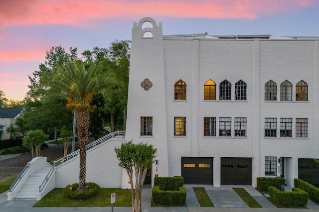 outdoor building at dusk featuring a garage