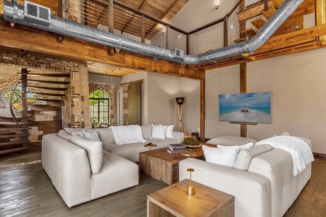 living room featuring dark hardwood / wood-style flooring and a towering ceiling