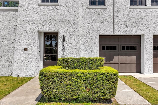 view of exterior entry featuring a garage