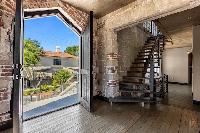 doorway to outside with vaulted ceiling, hardwood / wood-style flooring, and wood ceiling