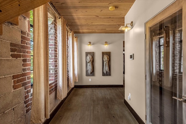 hallway featuring dark hardwood / wood-style flooring and wood ceiling