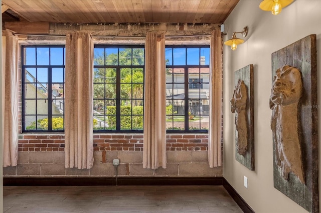 entryway with wood ceiling, a healthy amount of sunlight, and wood-type flooring