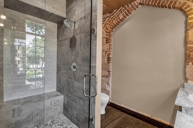 bathroom featuring walk in shower, hardwood / wood-style floors, vanity, and toilet