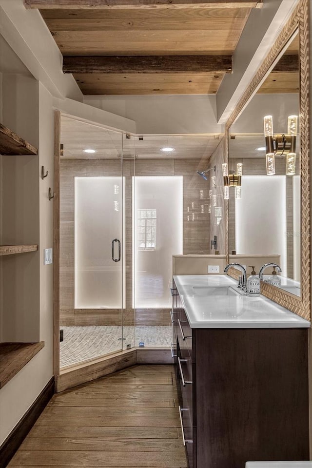 bathroom with beamed ceiling, walk in shower, vanity, and hardwood / wood-style flooring