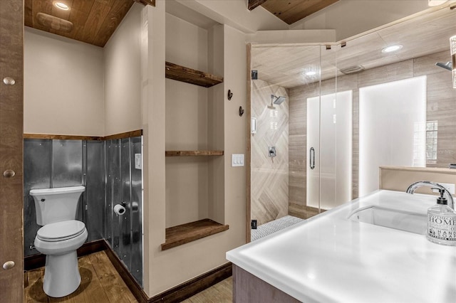 bathroom featuring walk in shower, hardwood / wood-style flooring, vanity, and toilet