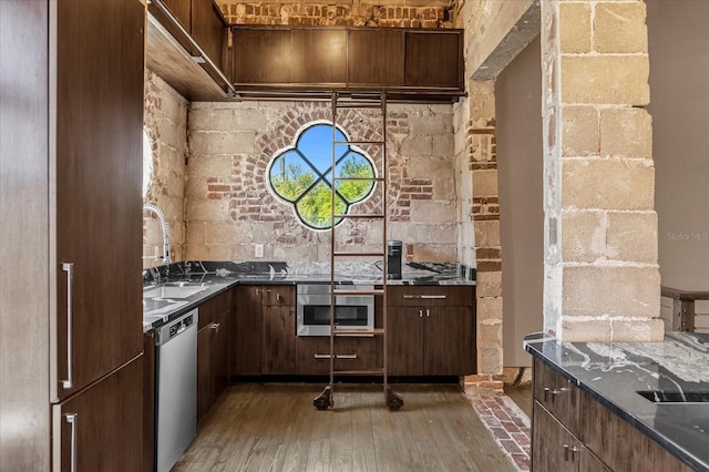 kitchen with wood-type flooring, dark brown cabinets, sink, and stainless steel appliances