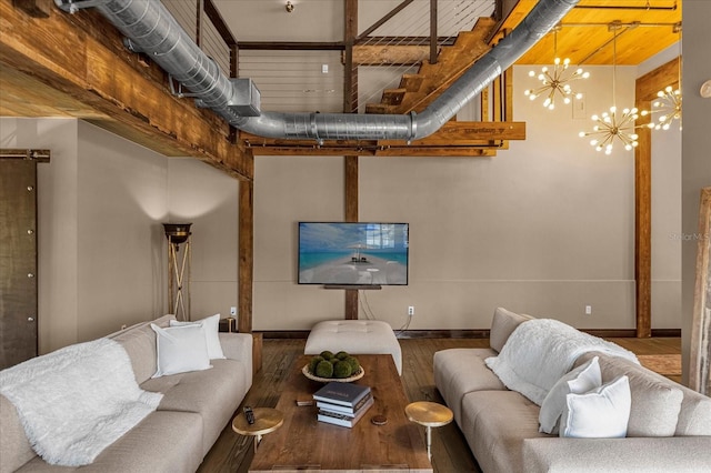 living room with wood-type flooring and an inviting chandelier