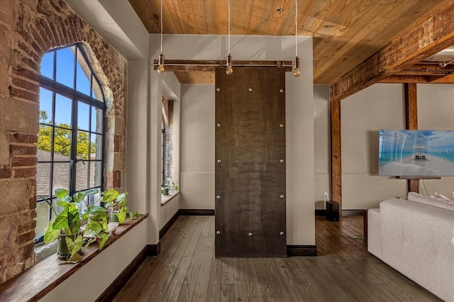 interior space featuring wood ceiling, a barn door, and dark hardwood / wood-style flooring