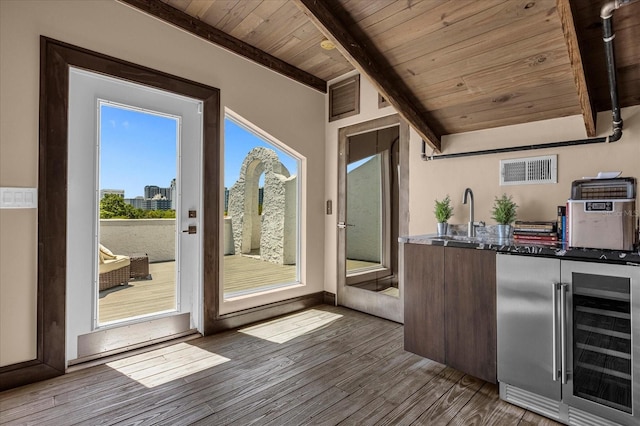 interior space featuring beverage cooler, wooden ceiling, dark hardwood / wood-style flooring, and sink