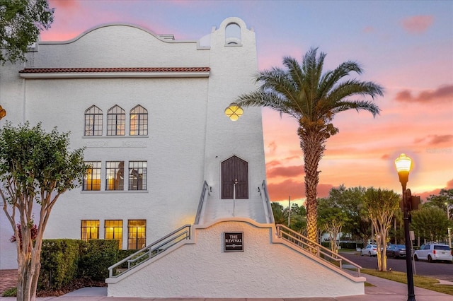 view of outdoor building at dusk