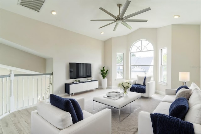 living room featuring wood finished floors, visible vents, lofted ceiling, recessed lighting, and ceiling fan