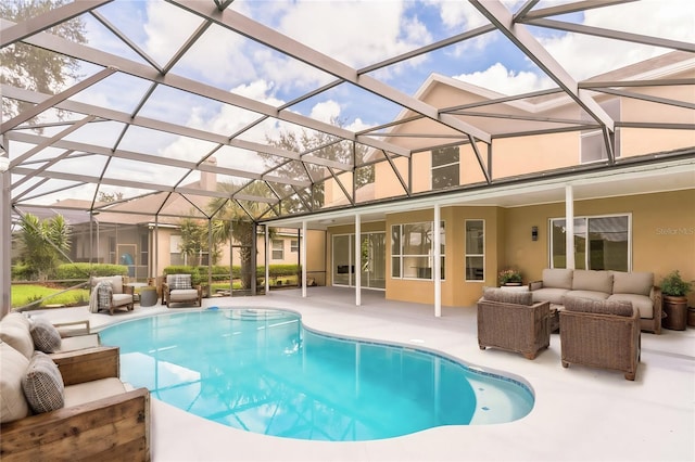 outdoor pool with a patio area, an outdoor hangout area, and a lanai