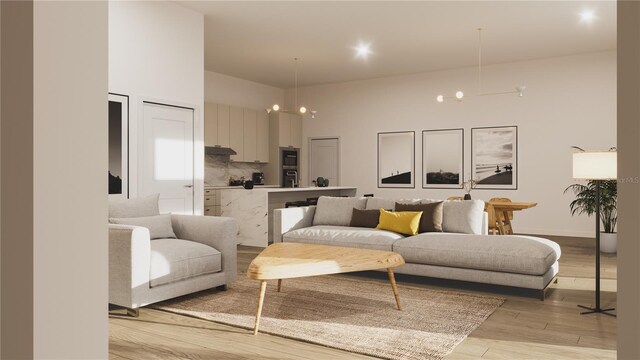 living room featuring a towering ceiling and light wood finished floors