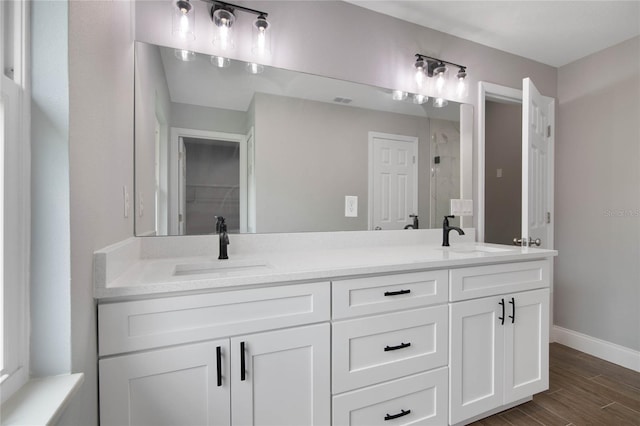 bathroom featuring a shower, vanity, and wood-type flooring