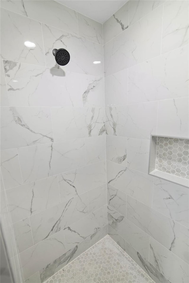 bathroom with a tile shower