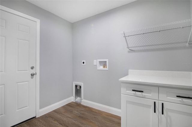 laundry room featuring hookup for an electric dryer, washer hookup, dark hardwood / wood-style floors, and cabinets