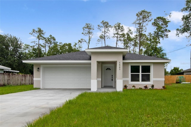 view of front of house with a front yard and a garage