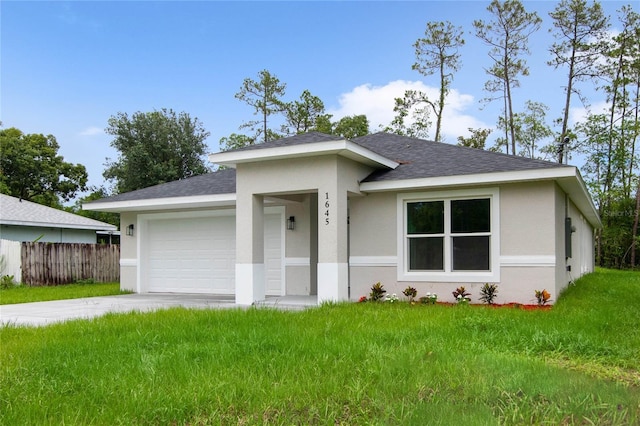 view of front of property featuring a garage and a front lawn