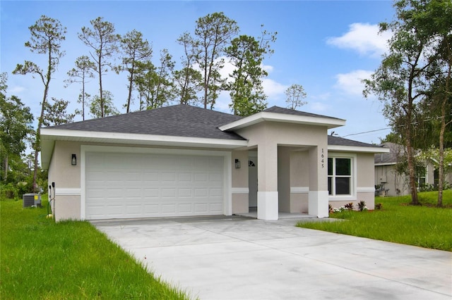 view of front of house with a front lawn, a garage, and central AC