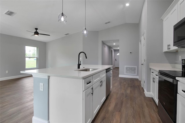 kitchen featuring a center island with sink, sink, white cabinetry, and stainless steel appliances