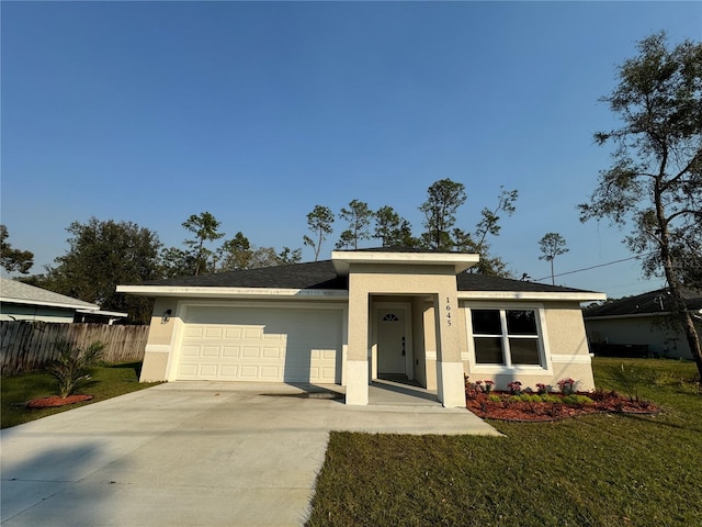 view of front of property with a garage and a front yard