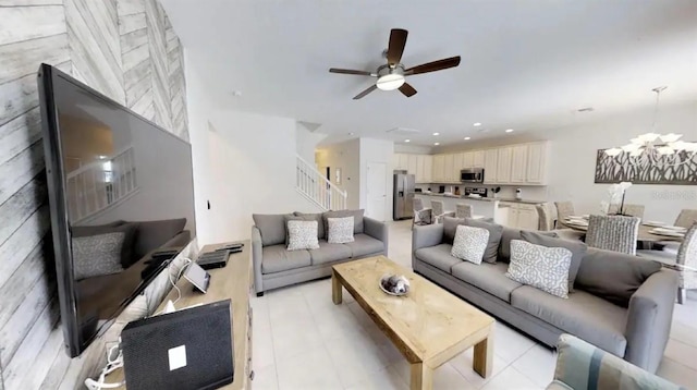 living room with ceiling fan with notable chandelier