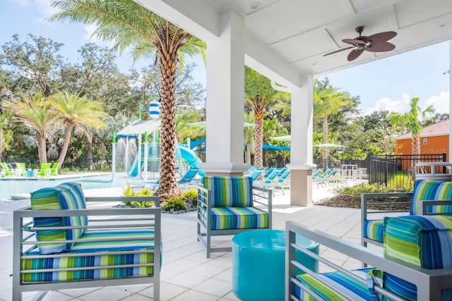 view of terrace with ceiling fan and a community pool