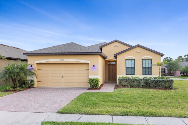 view of front of house with a front yard and a garage