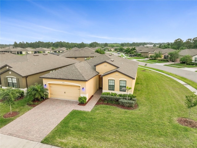 view of front of property featuring a front lawn and a garage