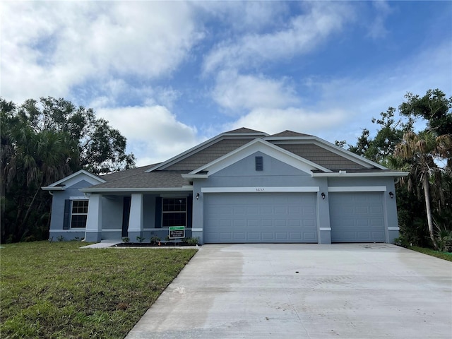 view of front of home with a garage and a front yard