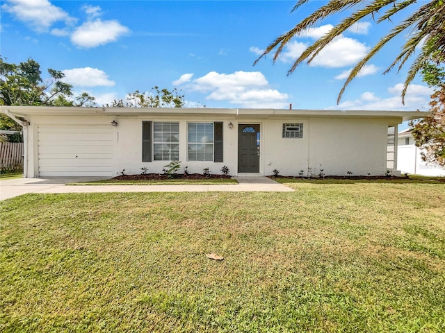 single story home featuring a garage and a front lawn