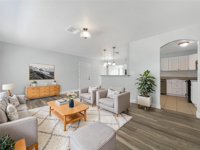 living room with an inviting chandelier and hardwood / wood-style floors