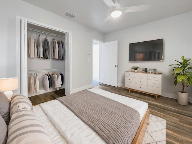 bedroom featuring hardwood / wood-style flooring, ceiling fan, and a closet