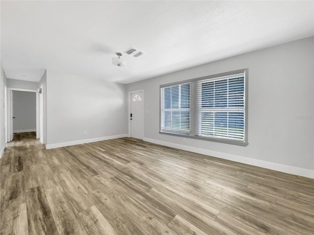 empty room with hardwood / wood-style flooring