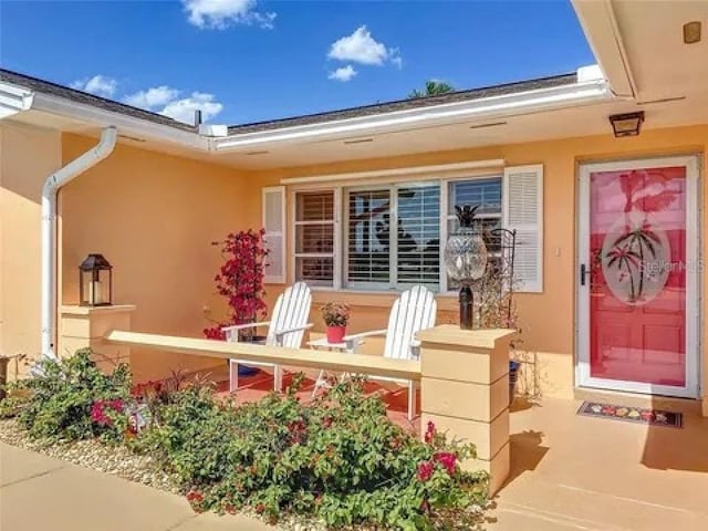 entrance to property featuring stucco siding