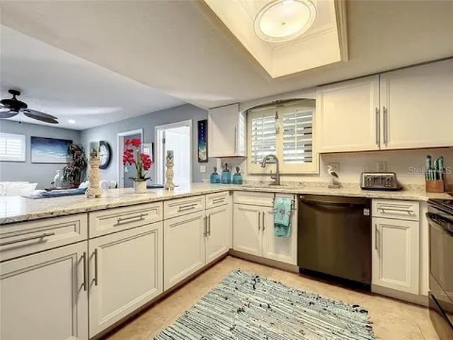 kitchen with ceiling fan, a sink, stainless steel dishwasher, range, and light stone countertops