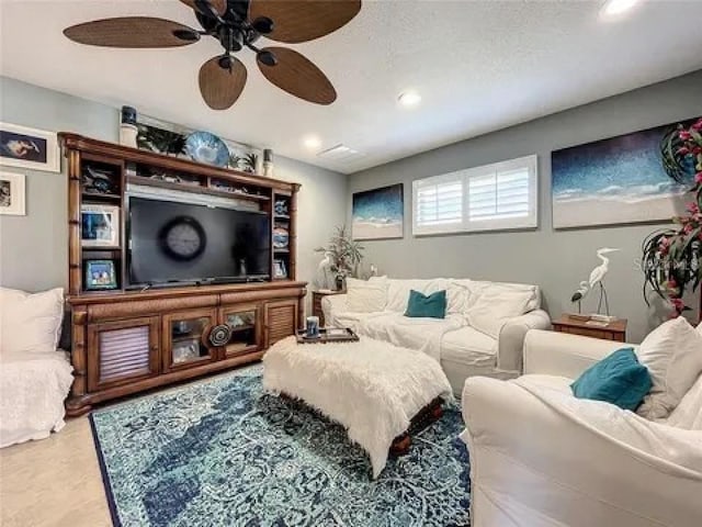 living room featuring a ceiling fan and recessed lighting