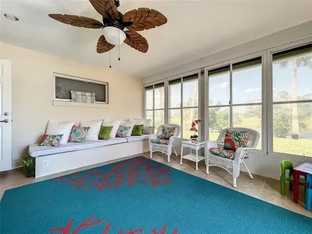 sitting room featuring ceiling fan and tile patterned flooring