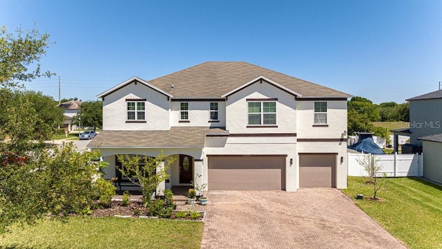 view of front of property with a front lawn and a garage